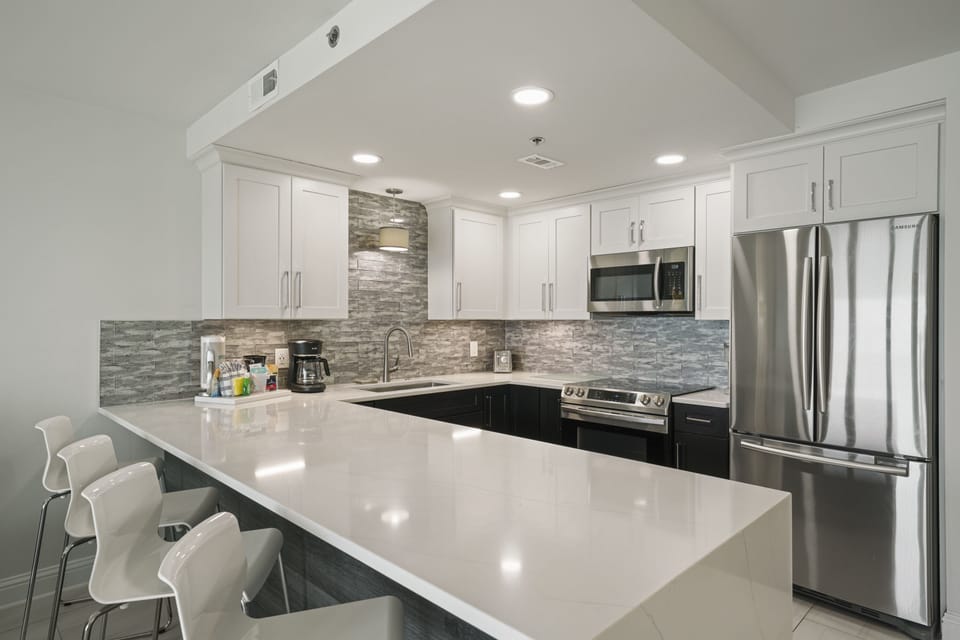 Luxury Destin beachfront condo kitchen with oversized island seating and upgraded cabinetry