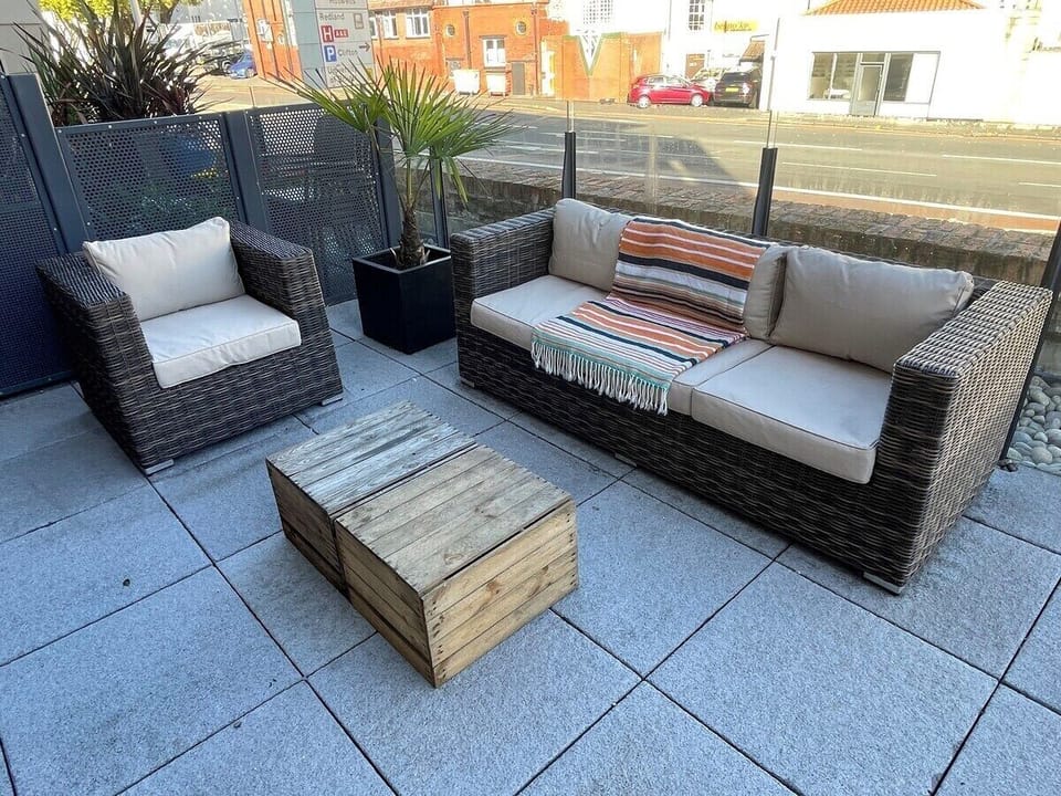 The terrace which features lounging furniture and as well as a 8 seater table
