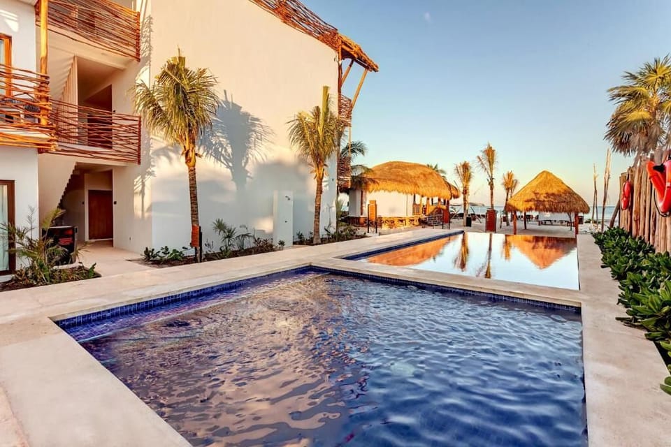 Float into golden hour in the serene, palm-lined pool.