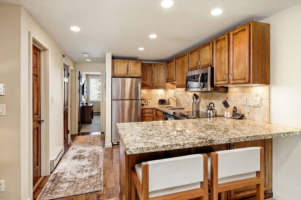 The kitchen has beautiful finishes and is fully stocked to make it very easy to dine in during your stay.