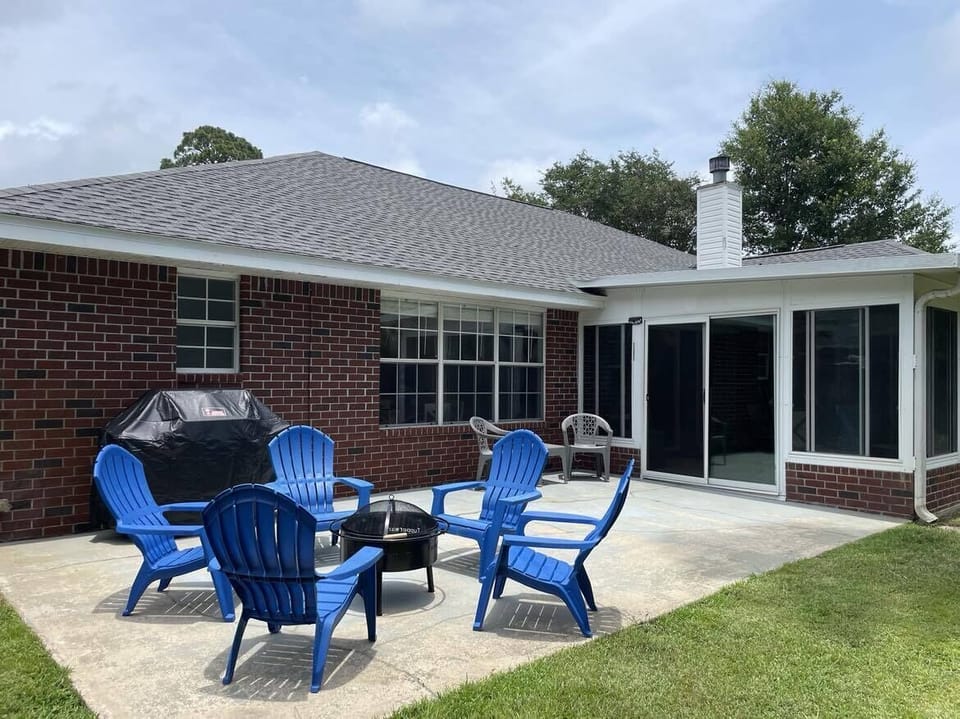 Back patio has a firepit, chairs, and a Weber grill.  