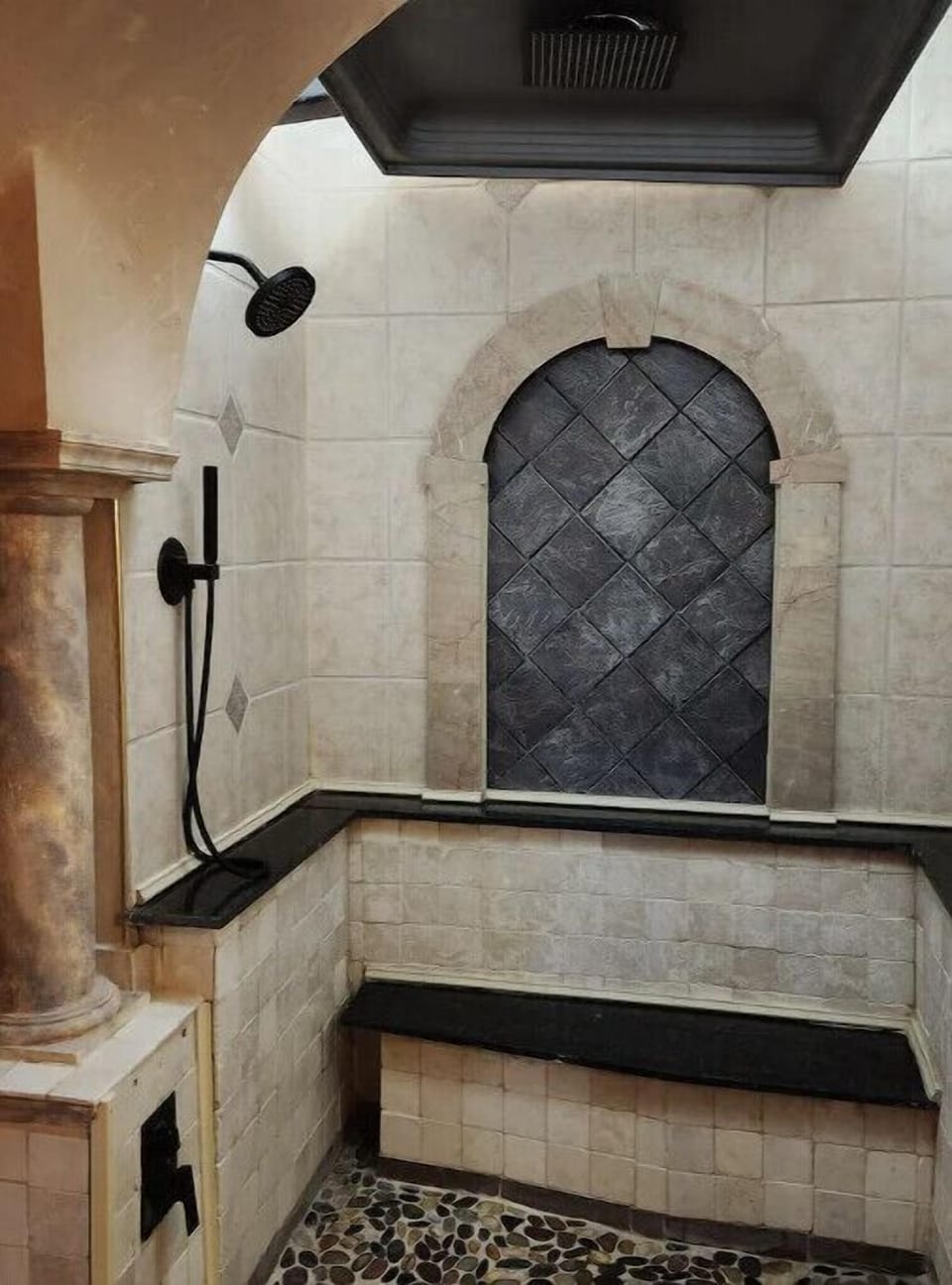 Shower features an overhead rain forest head, wall shower and spray wand.