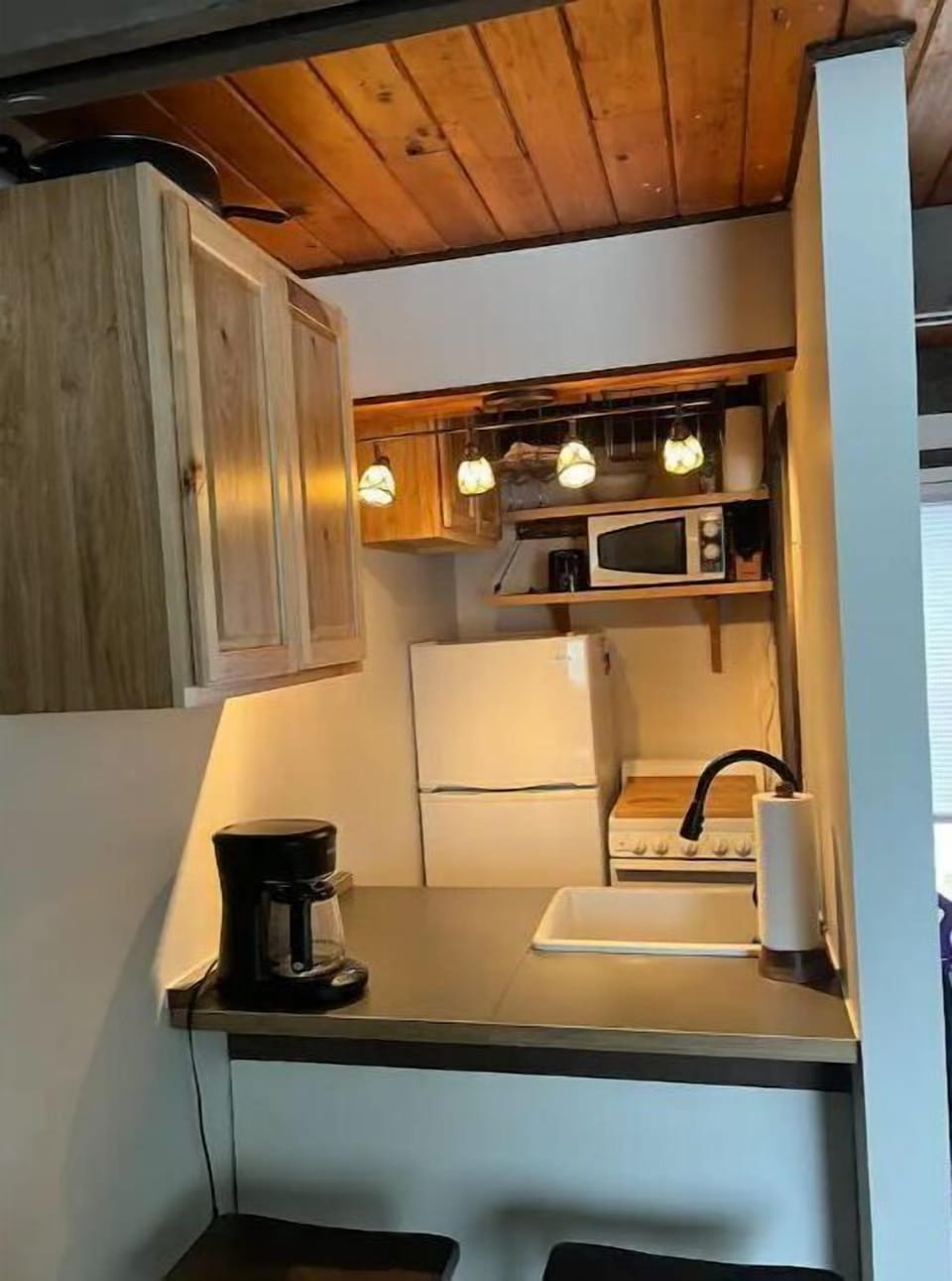 Kitchen with Bar Seating and Drip Coffee Maker