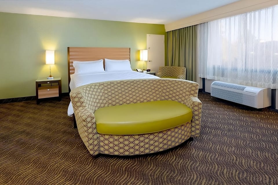 Drift off in a cozy king-style bed with soft lighting.