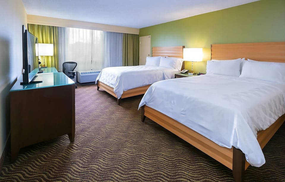 Unwind in bright, spacious comfort with crisp linens.
