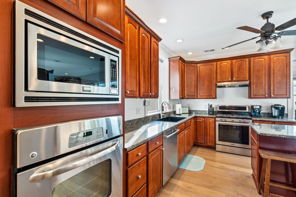 Two ovens and hallway from 2nd bedroom leading to kitchen. 