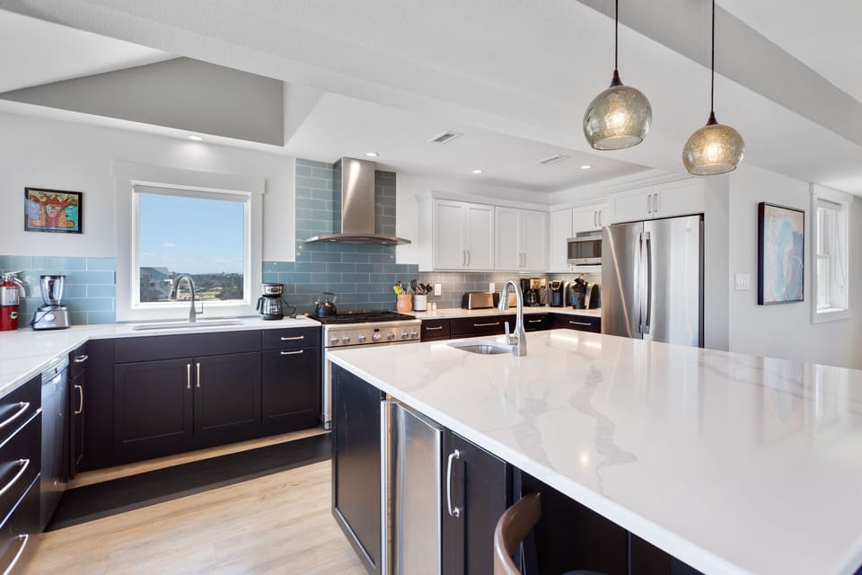 Whip up some fresh, local seafood in the Gourmet Kitchen with a commercial oven/range, sparkling quartz countertops, and plenty of prep space, including a prep sink and an ice maker.