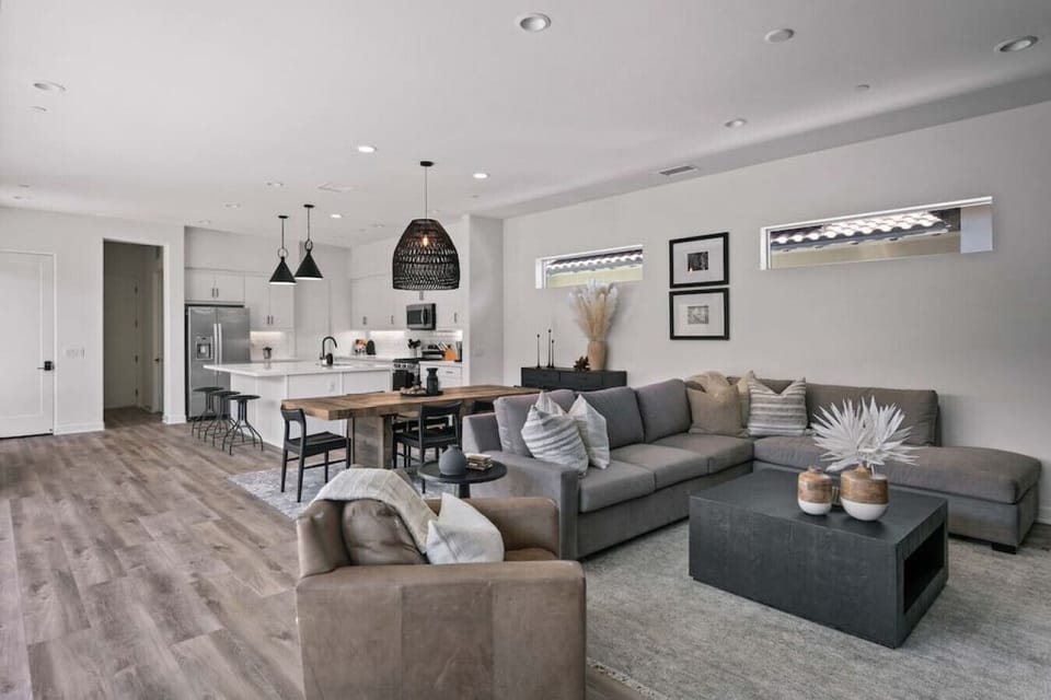 Bright open living area w/ comfy seating, TV & seamless flow into dining space