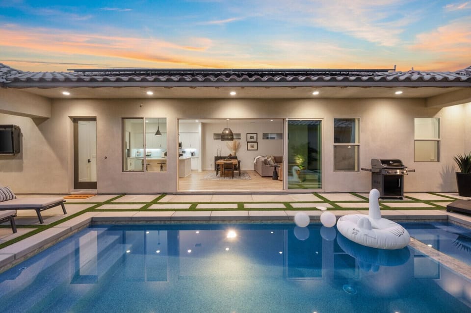 Enjoy evenings by the pool w/ covered patio seating & a peaceful backyard setting