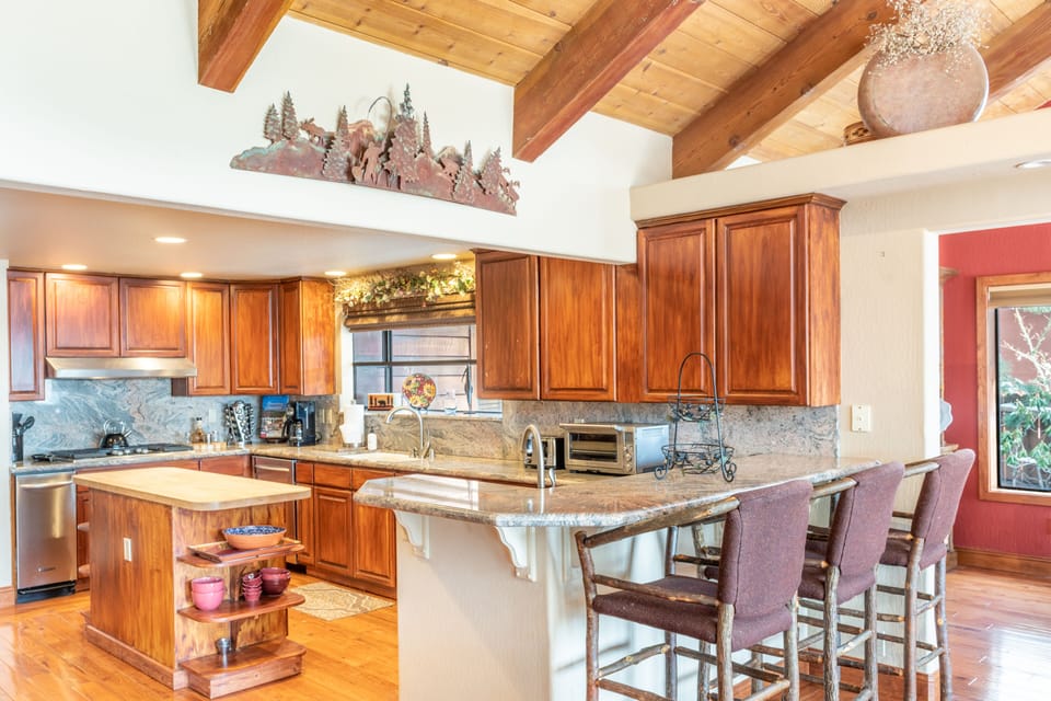 Fully-equipped kitchen with an island and barstool seating.