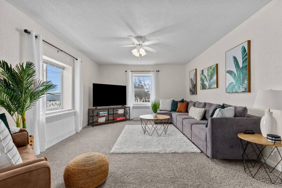 Spacious and comfortable living area. Large windows allow natural light to stream in and brighten the entire room.