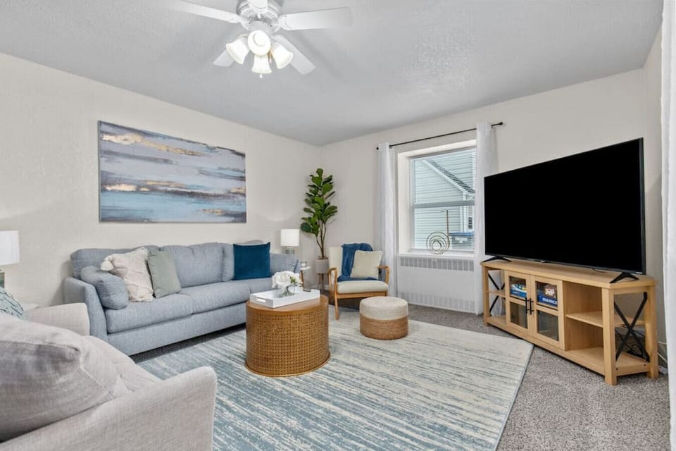 Spacious and comfortable living area has plenty of seating for family and friends. 65` Roku TV.