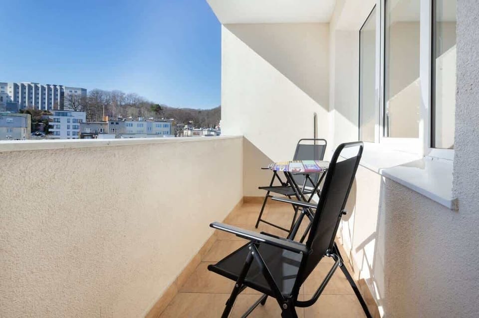 Spacious balcony with outdoor furniture. 