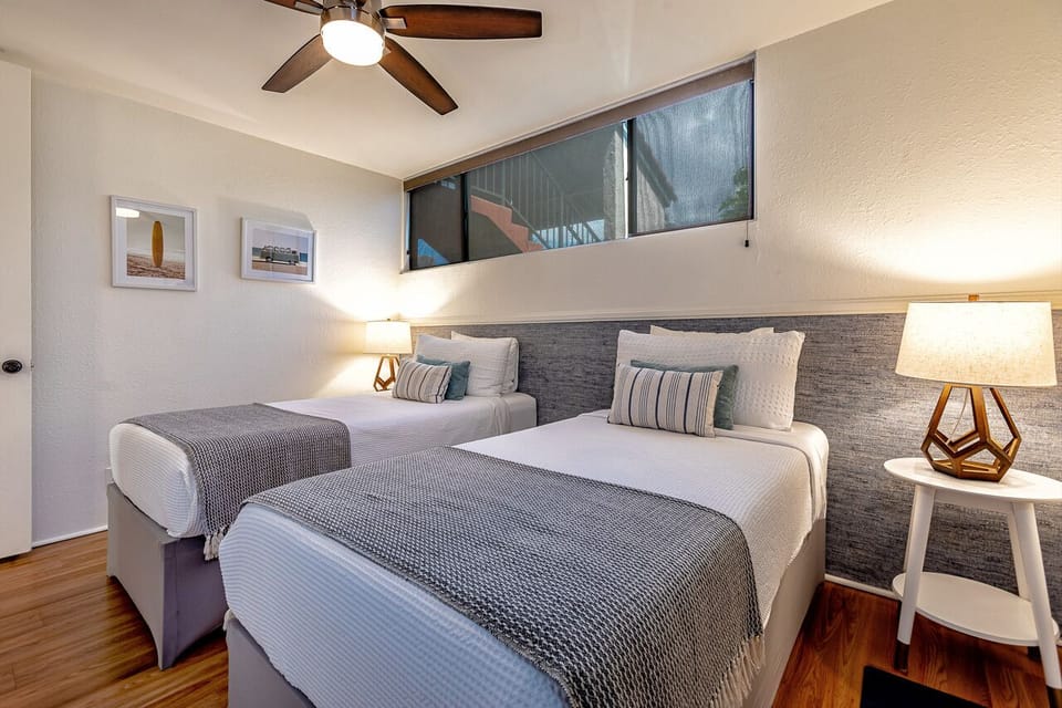 Cozy guest bedroom with windows to bring in the natural light.