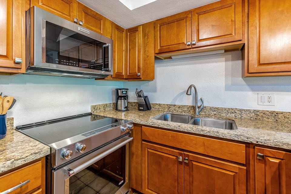 Spacious kitchen with new cabinets and stainless appliances. 