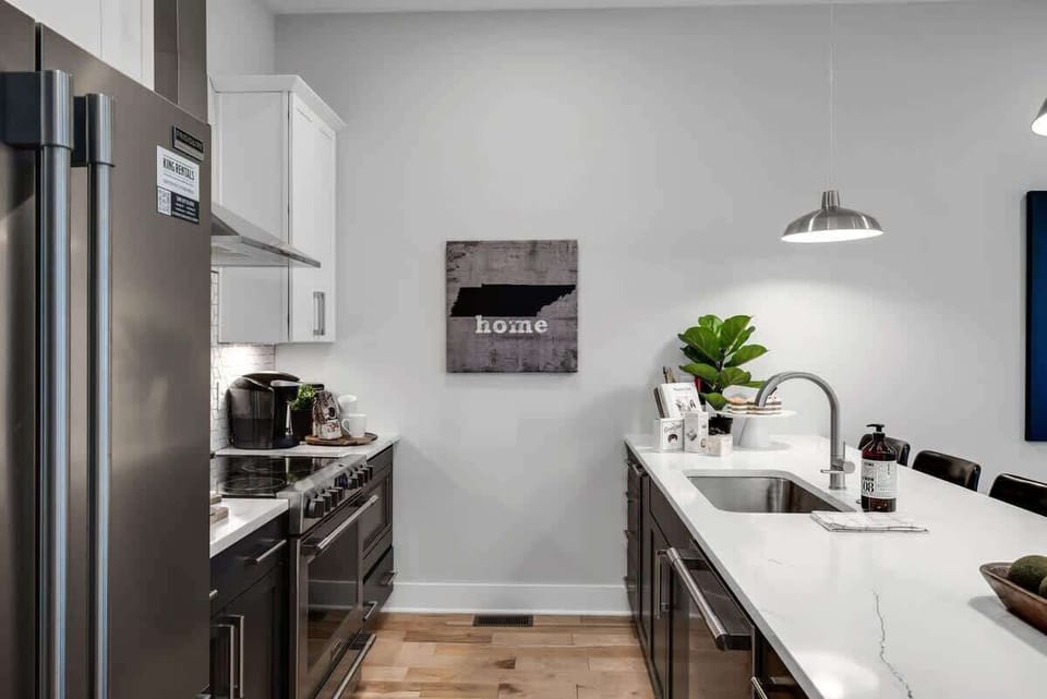 Kitchen with sleek brown cabinets and crisp white counters.