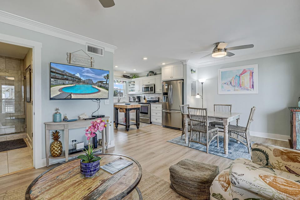 Relax in your bright, open-concept space where coastal charm meets modern comfort, complete with a fully equipped kitchen and dining area.