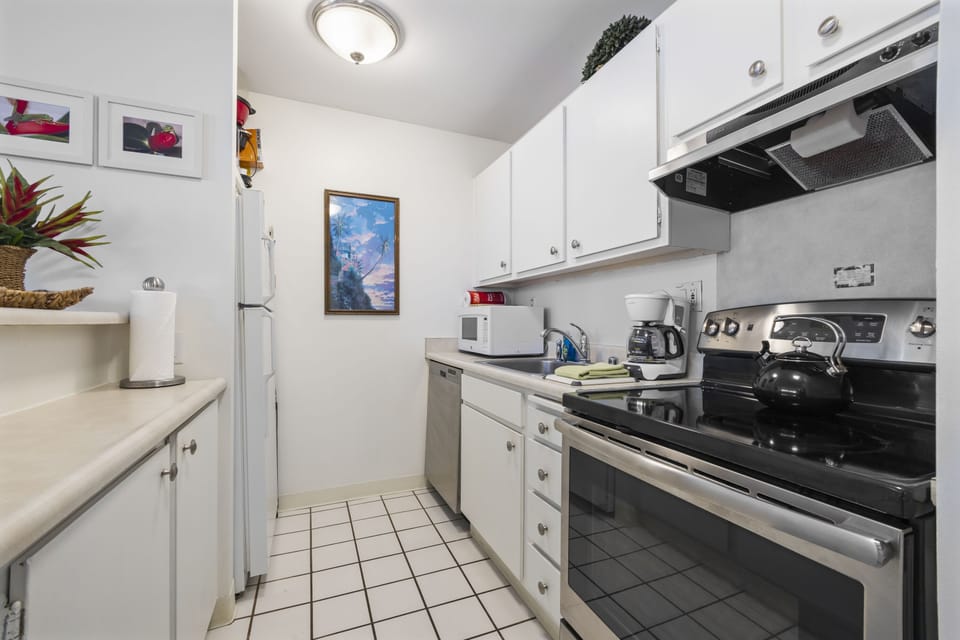 Step into your fully equipped kitchen, where you'll find everything you need to prepare meals during your stay, from modern appliances to ample counter space.