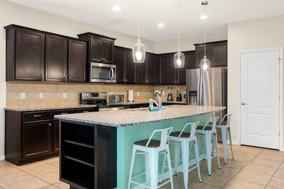 Modern kitchen w/ sleek cabinets, island seating & a clean, open layout.