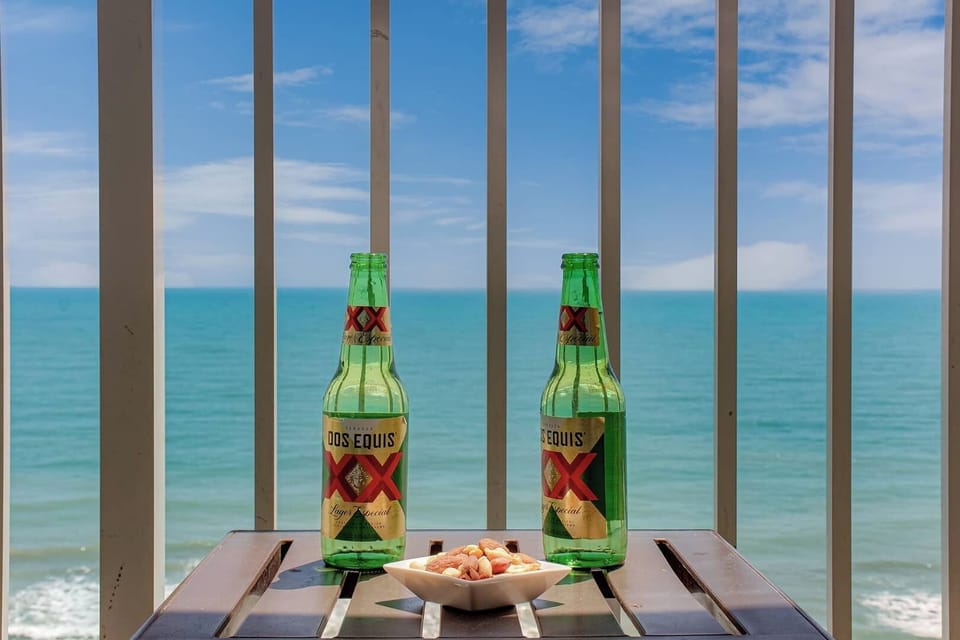 Enjoy a refreshing drink on your balcony, overlooking the waves