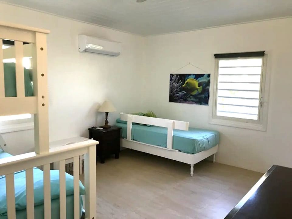 Bedroom with twin over full bunkbed and twin bed