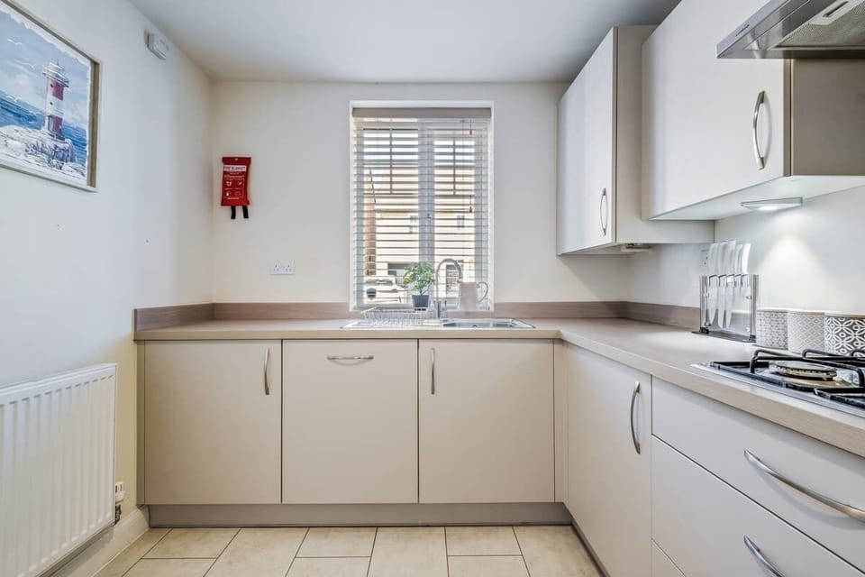 A well-equipped kitchen with all the essentials for your stay, including a washing machine