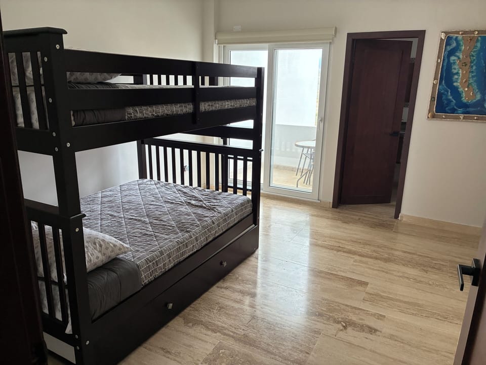 Bedroom with queen bunk bed + full bath and balcony