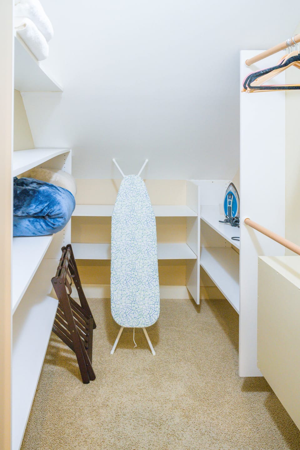 Walk-in closet with iron/board, extra towels and linens