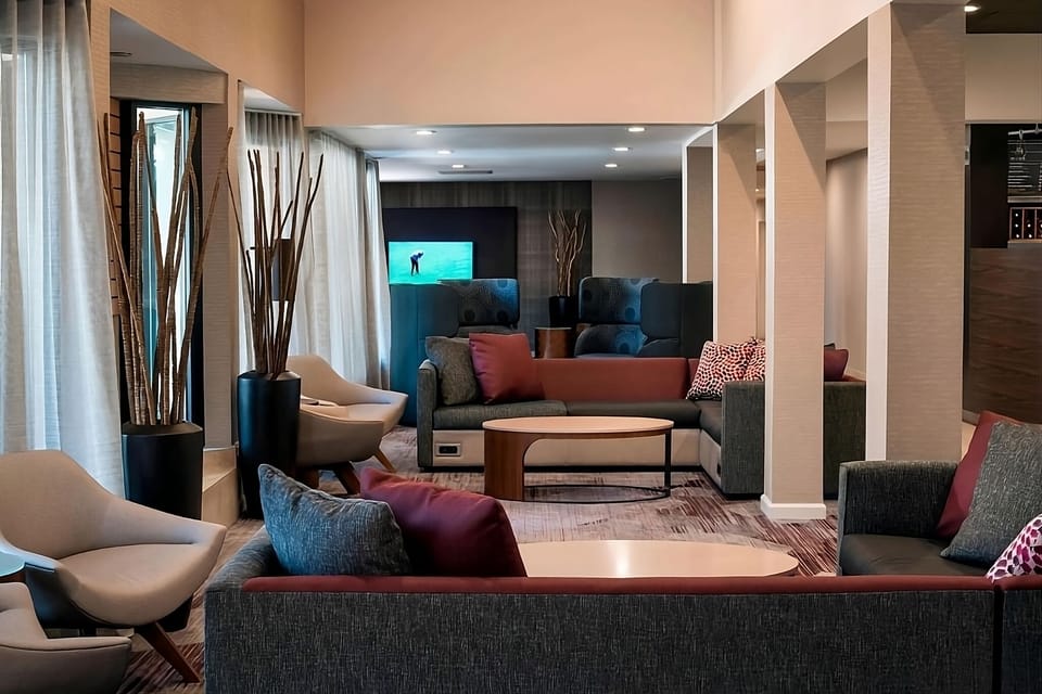 Unwind on plush sofas in a calm, stylish lounge.