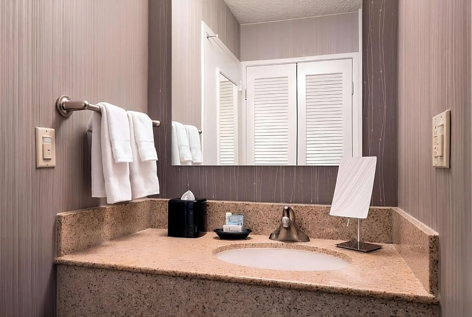 Refresh at the spacious vanity with bright, clean lighting.