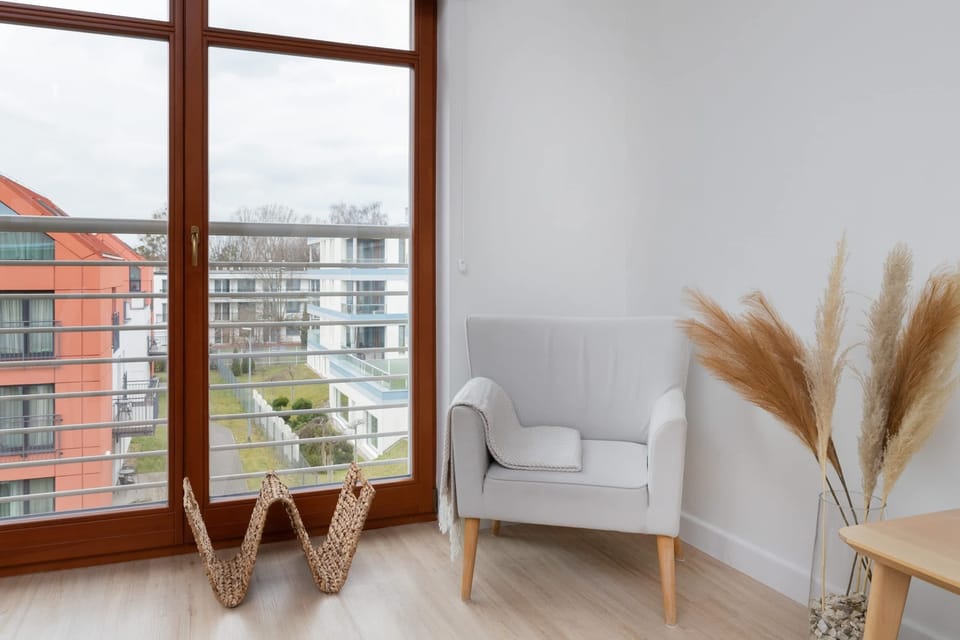 A cozy armchair near the window, perfect for enjoying natural light while reading or relaxing.