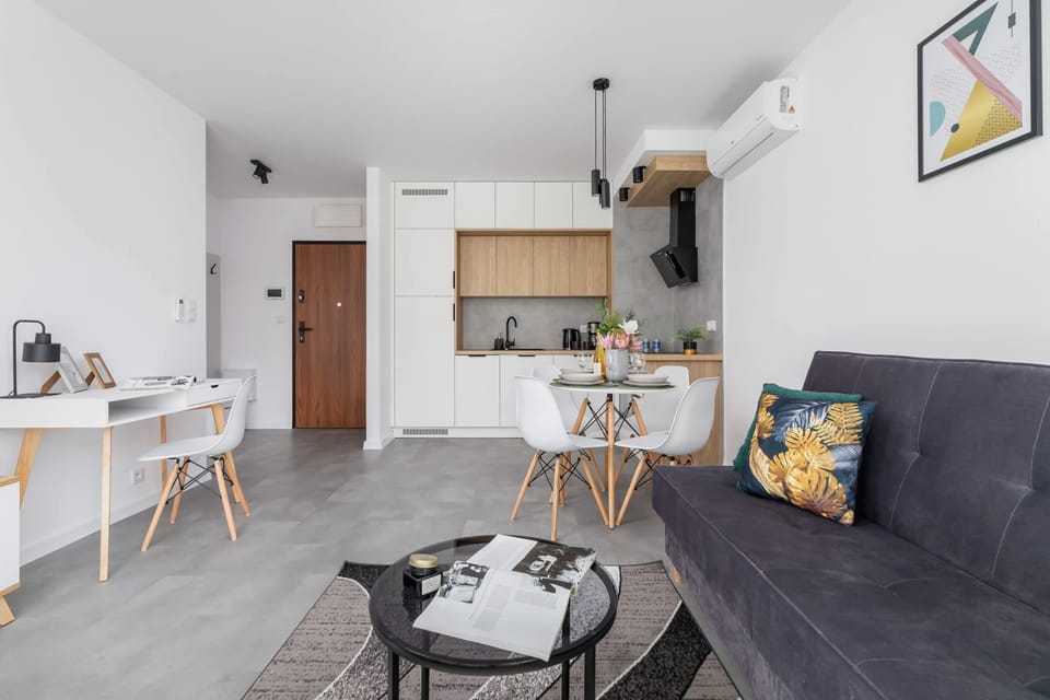 The living area with colorful cushions, a cozy ambiance, and a stylish coffee table.
