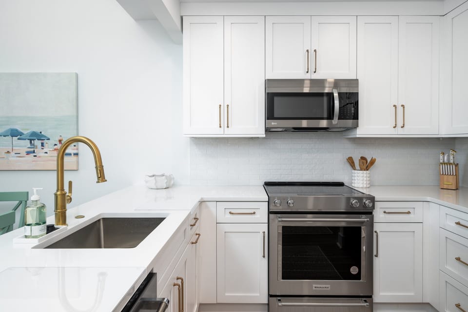 The renovated kitchen has granite counters and custom cabinets.  The kitchen comes fully stocked.