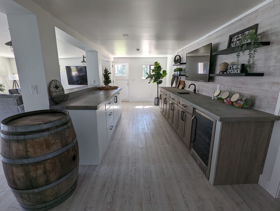 More living space in the walkout basement with bar, tv's & beverage center.