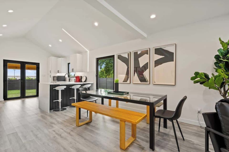 Enjoy meals on the large 8 person dining table or at the bar with tons of fresh open lighting.