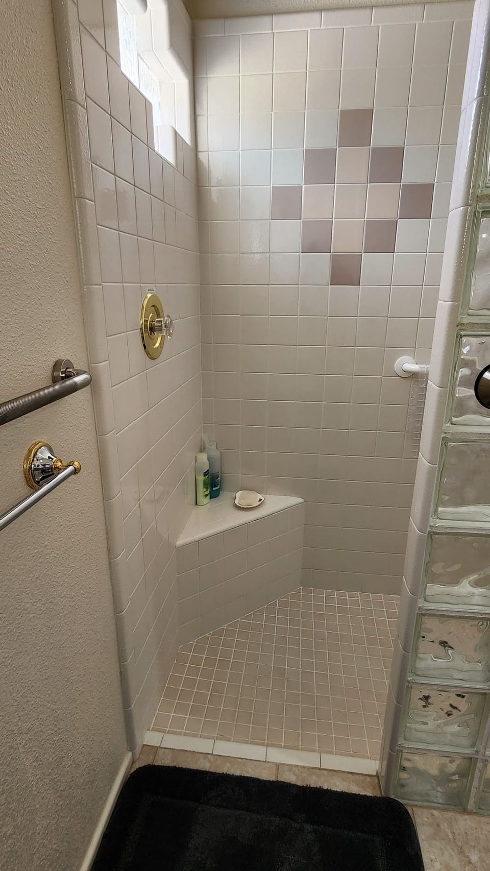 26 inch opening to walk in, doorless shower.  Adjustable shower bench available.