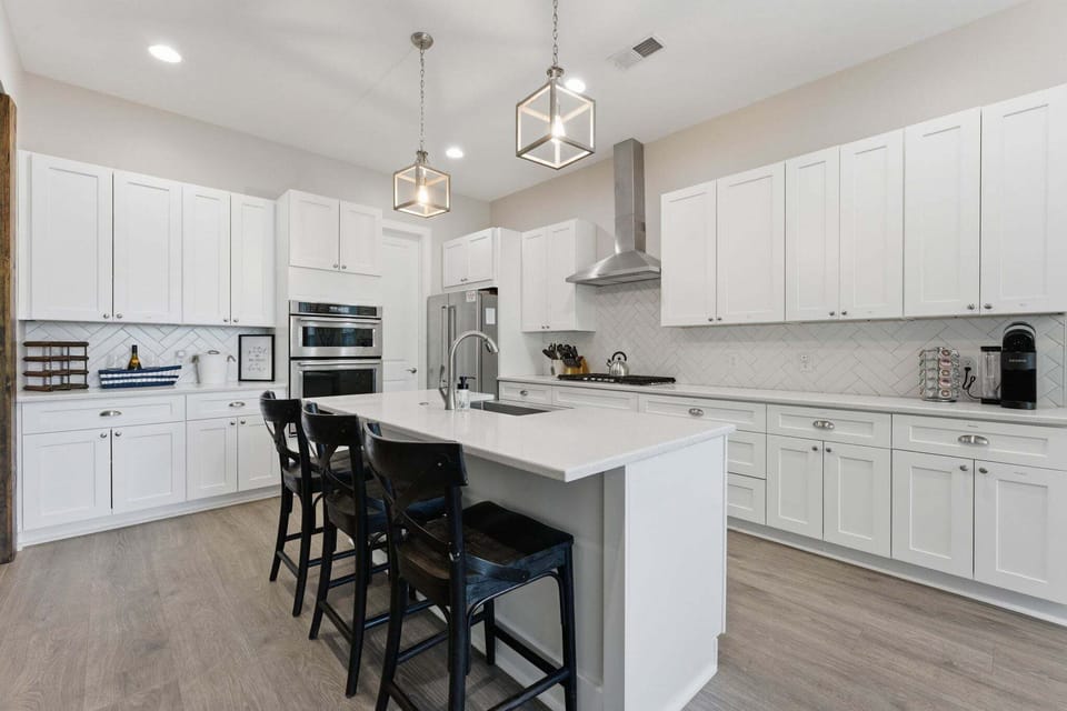 Large, modern fully stocked kitchen with island seating for 3.