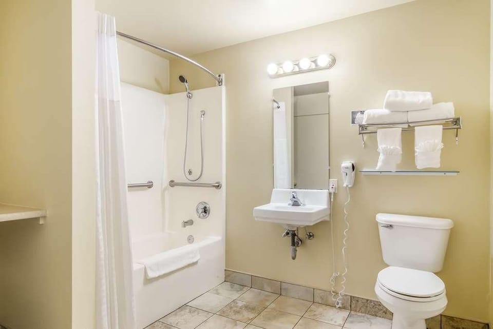 Refresh in a spotless bath with bright vanity lighting.