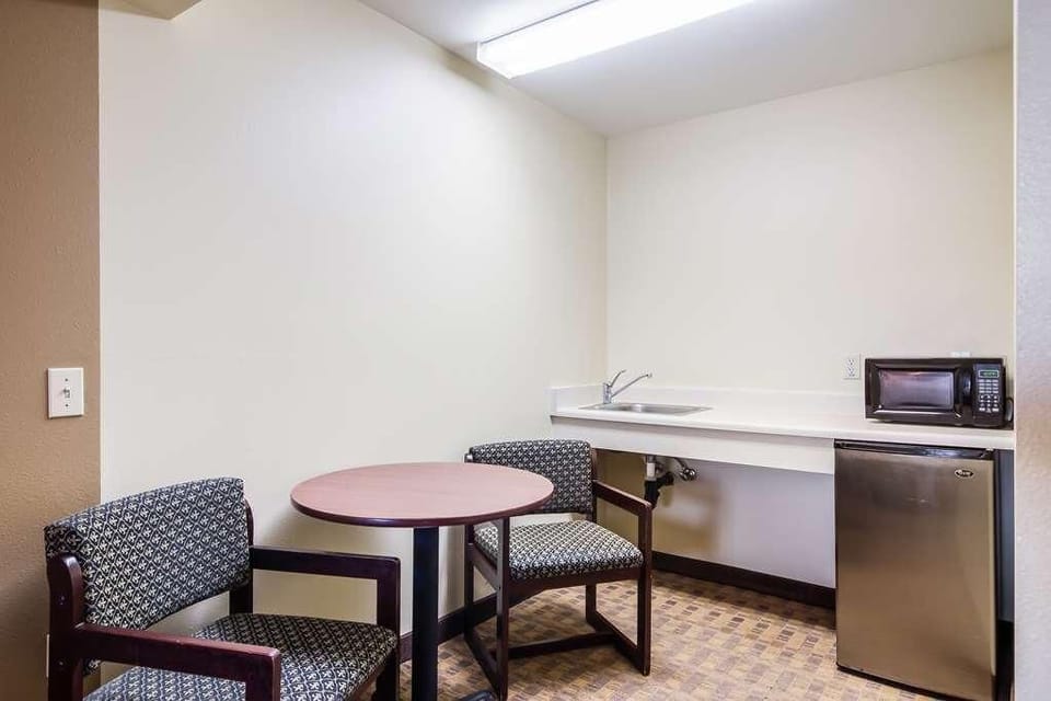 Enjoy quick meals with microwave, mini-fridge, and dining table.