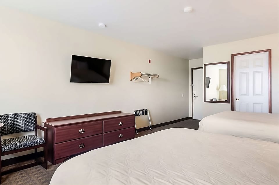 Kick back with wall-mounted TV, dresser storage, and seating.