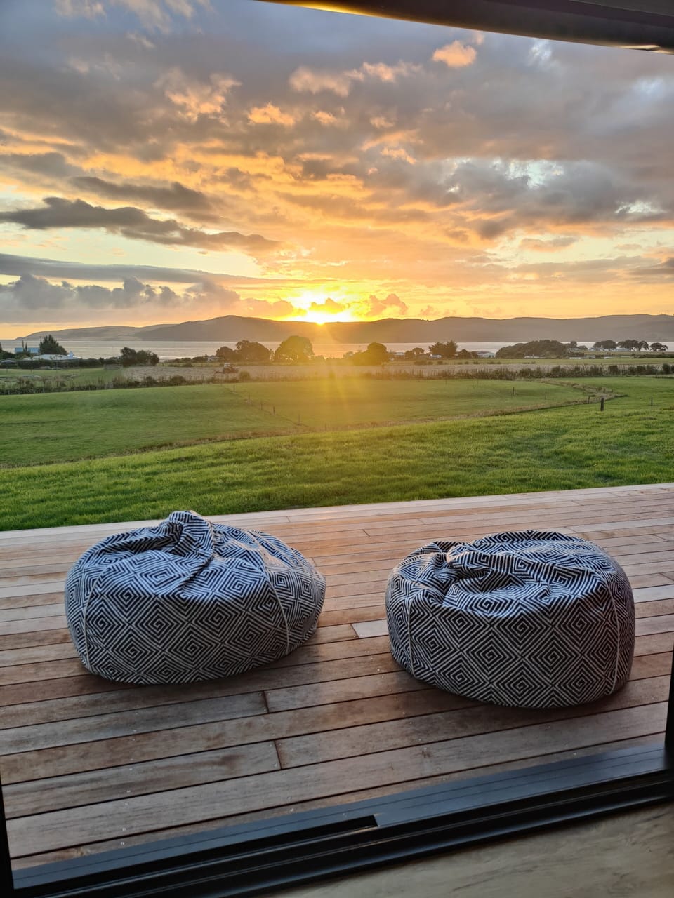 Relax, pull up a beanbag & take in the gorgeous sunsets over the Hokianga Heads.