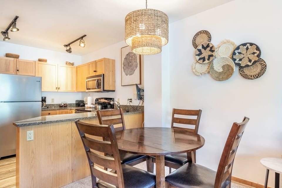 Your open-concept kitchen and dining area creates the perfect space for home-cooked meals together, with warm wood finishes and thoughtful details.