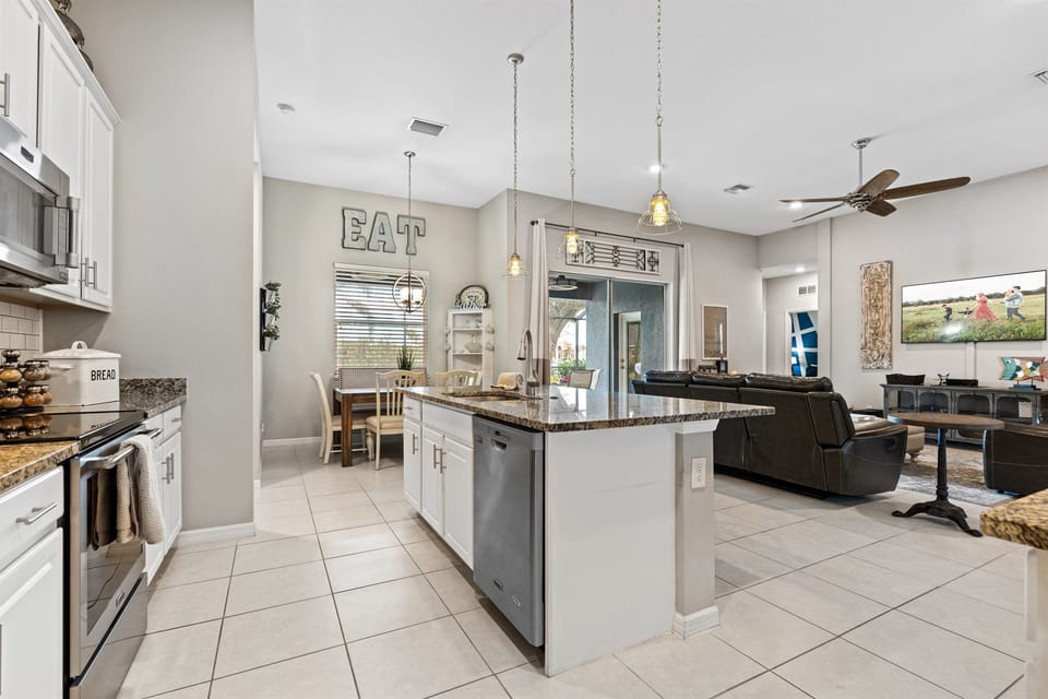 The kitchen eating area and the sliding glass door leading out to the pool area.