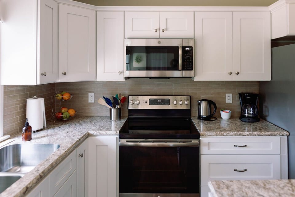 The kitchen is equipped with dishes, cookware, and utensils for meal preparation