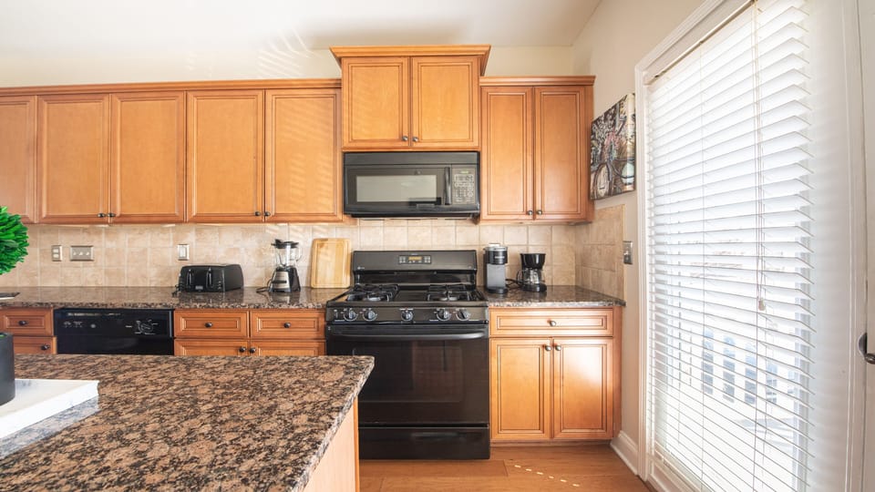 Modern cooking appliances and spacious countertops, the kitchen has it all!.