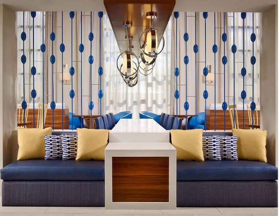 Sink into plush seating beneath warm lights and stylish screens.
