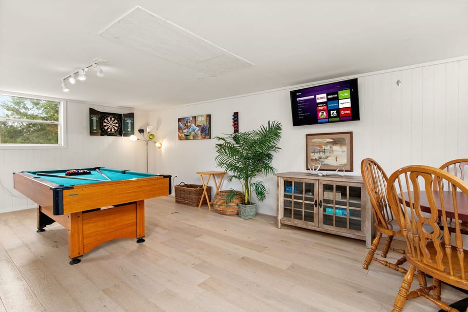 Pool table, dart board, Smart TV and card table. 