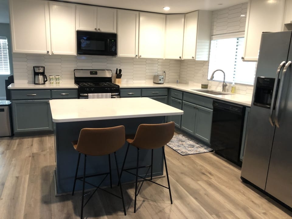 Newly renovated kitchen with two bar stools 