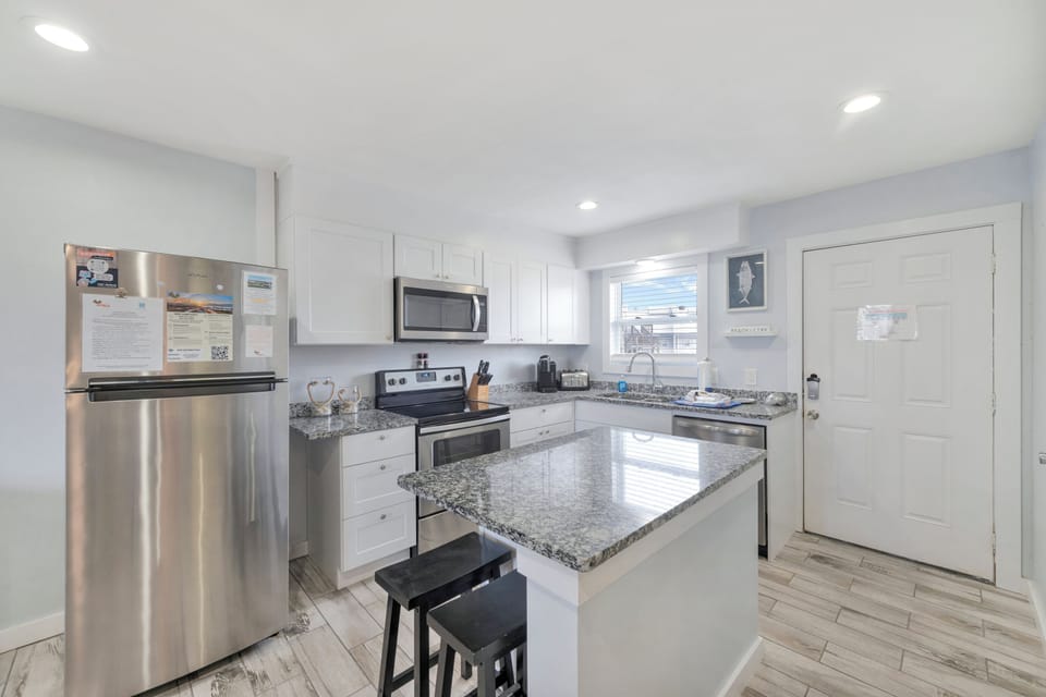 Your bright, modern kitchen awaits with granite counters, stainless appliances, and everything you need for memorable meals.