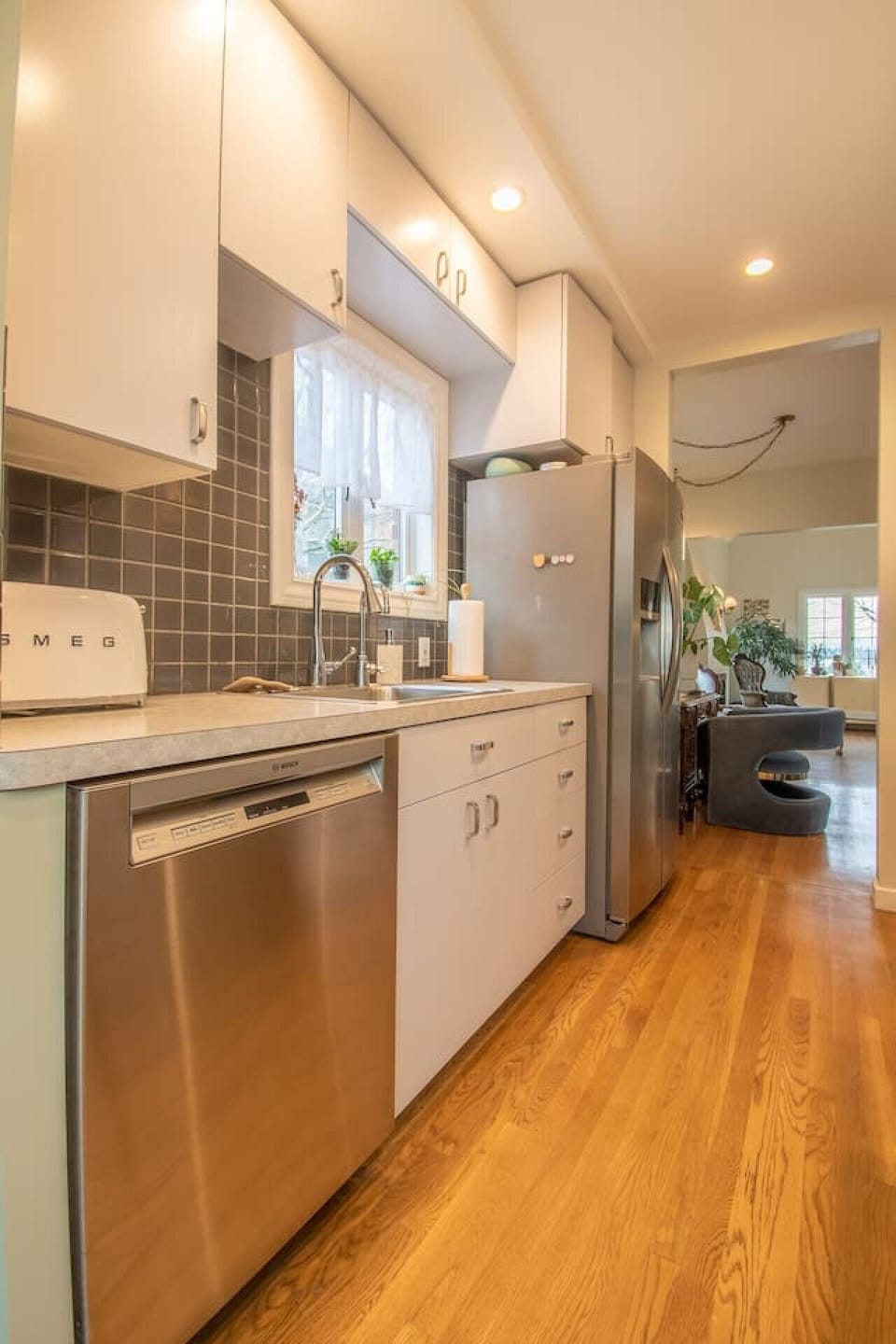The kitchen has all the essentials, stainless steel dishwasher, refrigerator, stove, and microwave.